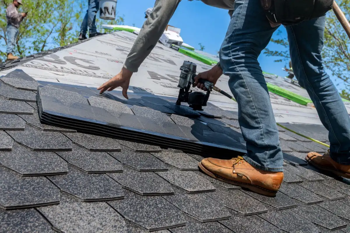 Inspecting an asphalt shingle slope after a hailstorm in New Rochelle, NY